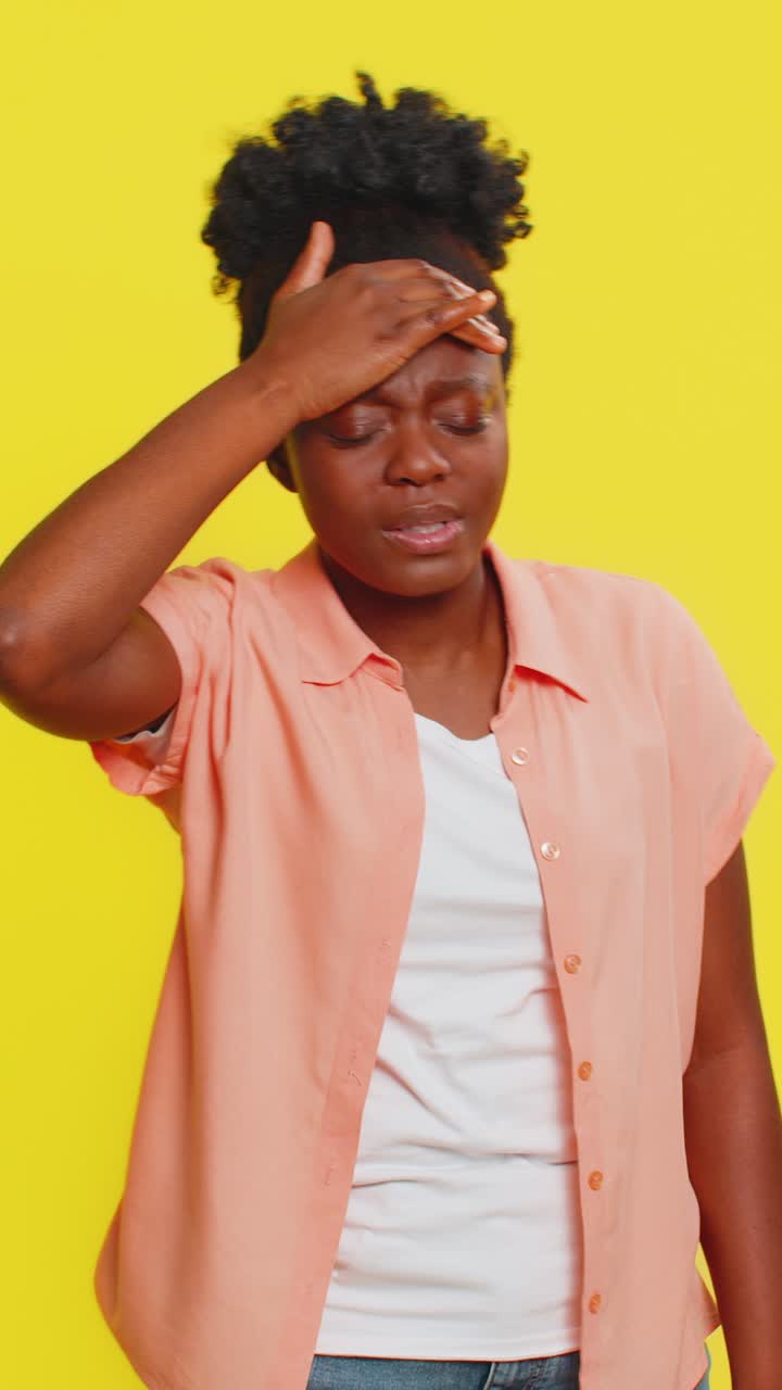 Black woman holding head unsteady posture dizzy expression struggling with balance weakness