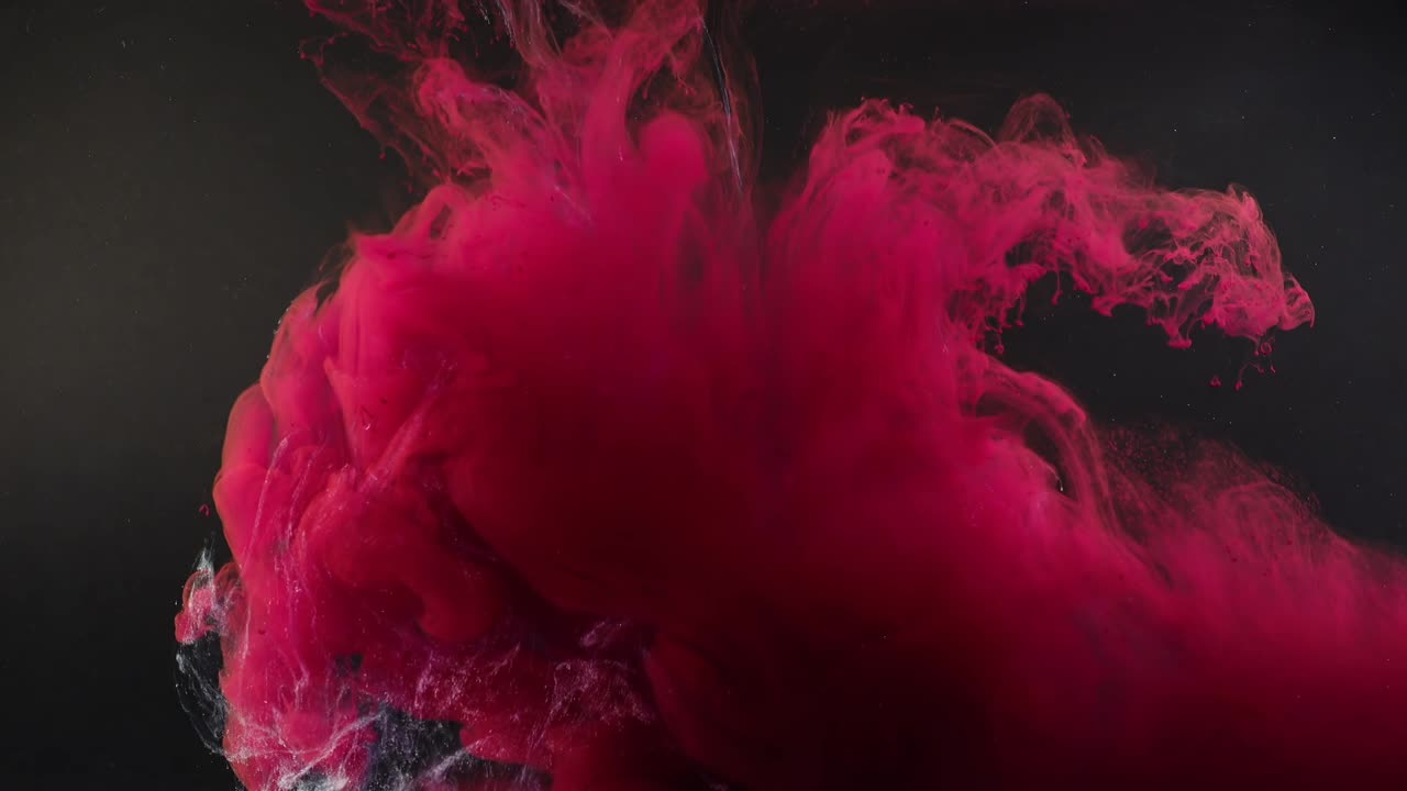 Abstract forms. Shooting on a black background. Mixing of paints