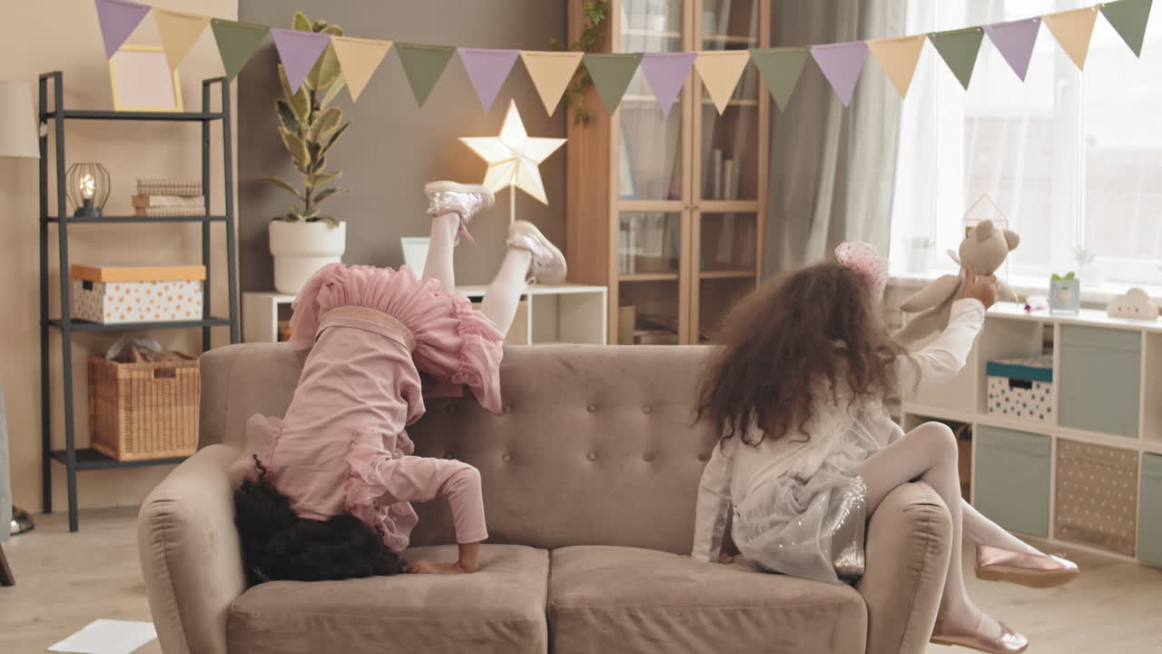 Little Sisters Rolling Around on Couch