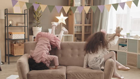 little sisters rolling around on couch