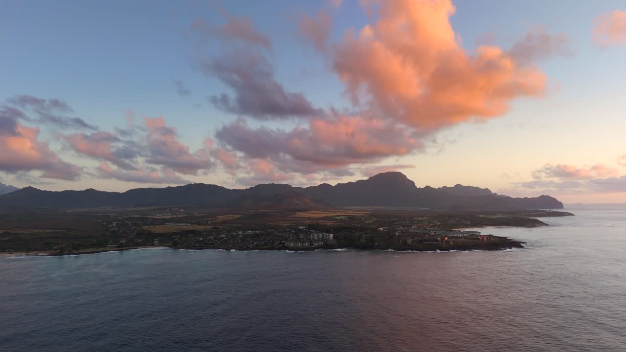 Witness a breathtaking sunrise over the Pacific Ocean in Hawaii, captured in 4K aerial footage during golden hour, highlighting the serene beauty of nature and the ocean.
