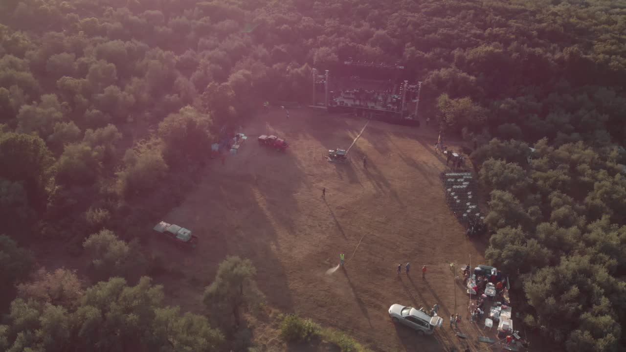 AERIAL drone footage of mountain forest and an outdoor music live stage  sea at background at Pelion Greece