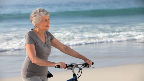 mature woman waiting with a bike