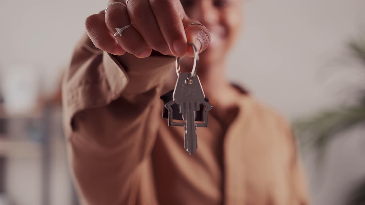 Young african american woman demonstrates keys to house or own real estate
