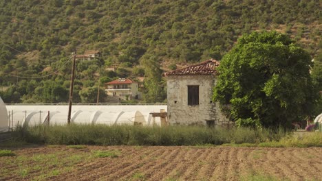 mediterranean town farmland field with steep dry shrubs on hillside, static