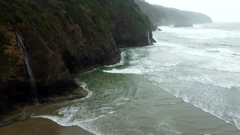 us, oregon, tillamook, cape lookout, 2025-02-19 - drone view of a tidefall (coastal waterfall) at cape lookout on the oregon coast in winter.