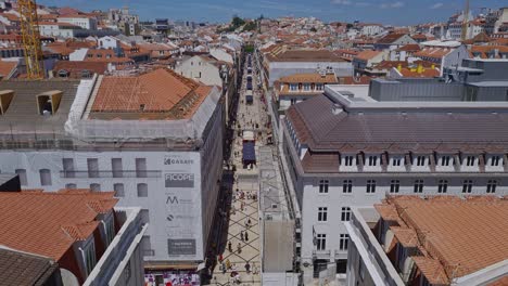 through the narrow streets of the city of lisbon people journey