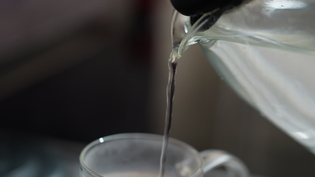 Steaming Water Flows Into Mug Peacefully, Gentle Cascade Of Boiling Water Lands In Ceramic Cup Smoothly, Tranquil Scene Of Hot Water Streaming From Kettle Into Cup During Daily Routine