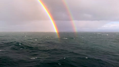 awesome and lovely, rare double rainbow from cruise ship in north sea off coast of norway at arctic circle near berents sea with white water waves, hd 1080p