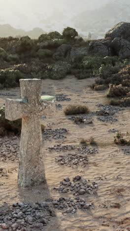 cruz de piedra en un paisaje desértico