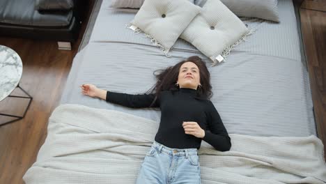 beautiful woman is testing a bed in a furniture store discounts on products black beautiful woman is testing a bed in a furniture store discounts on products black friday