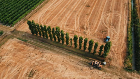 aerial view of agricultural fields with tractors