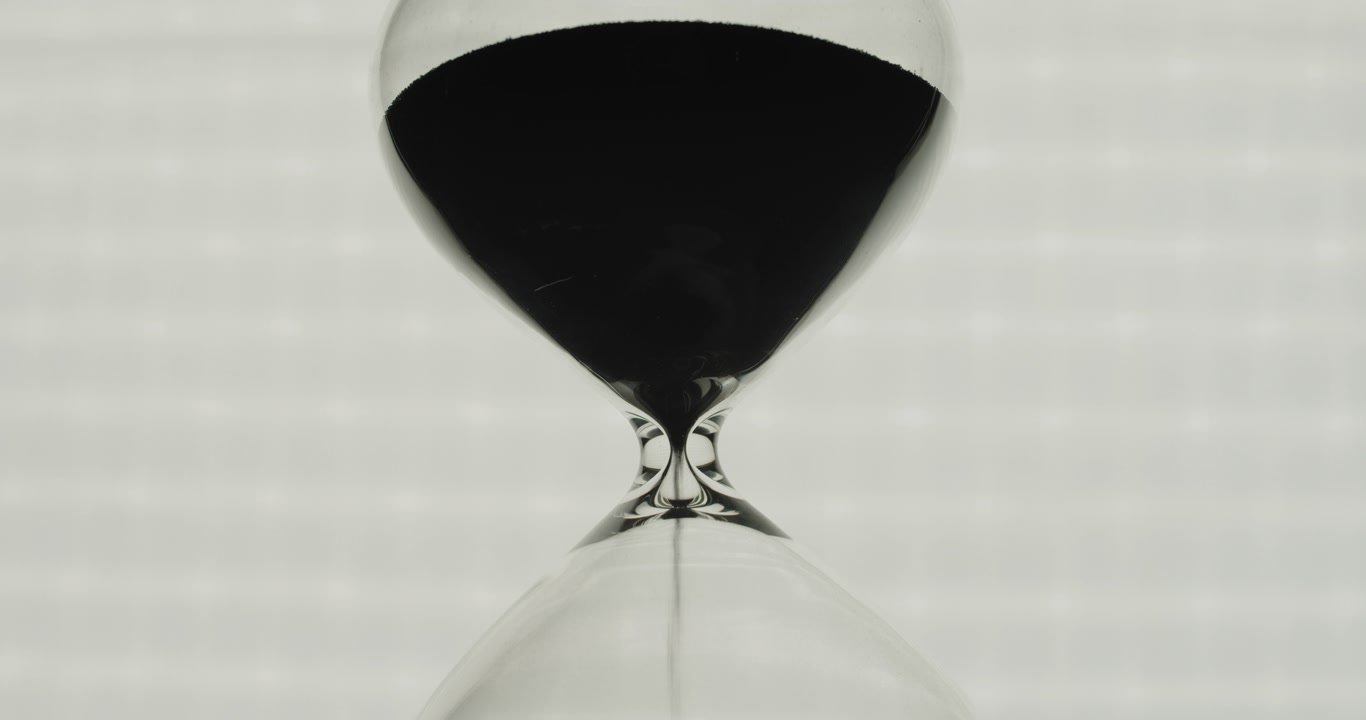 Close up of a sandglass with black sand