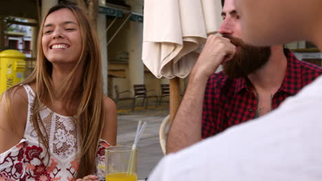 friends on vacation talking at a table outside a cafe, shot on r3d