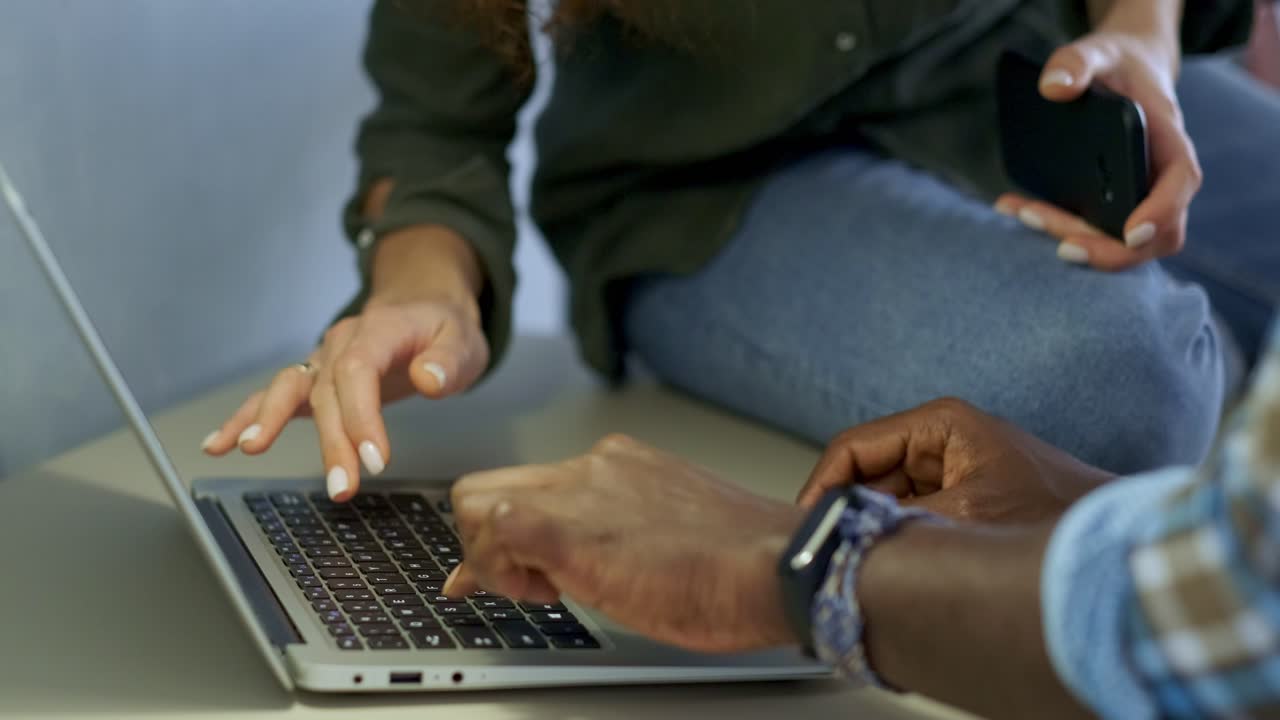 Two people collaborating on a laptop