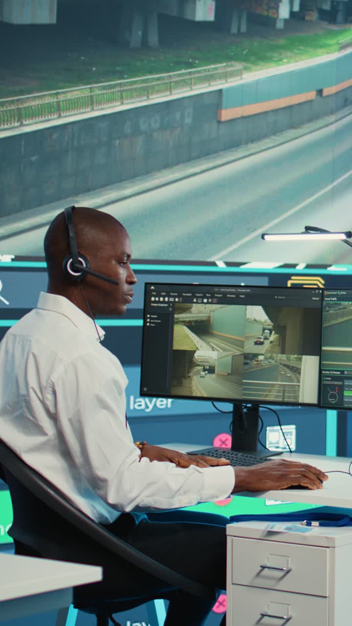 African American Man Monitoring Traffic on Computer in Control Room