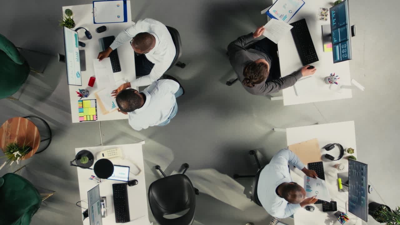 Top down view zoom in of diverse coworkers in office discuss budgeting