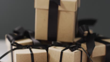 Brown-gift-boxes-with-black-ribbons-on-dark-grey-background