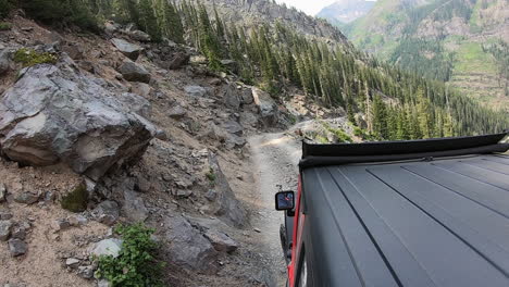 rooftop of 4wd vehicle creeping along narrow trail cut in mountain side above poughkeepsie gulch near ouray colorado