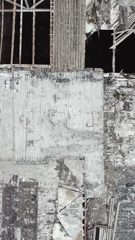 ruined roof of an old abandoned factory. aerial view. vertical video