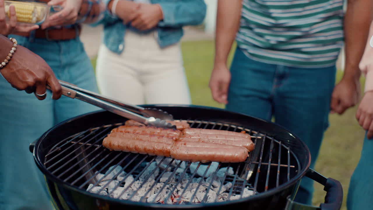 People grilling sausages on a barbecue