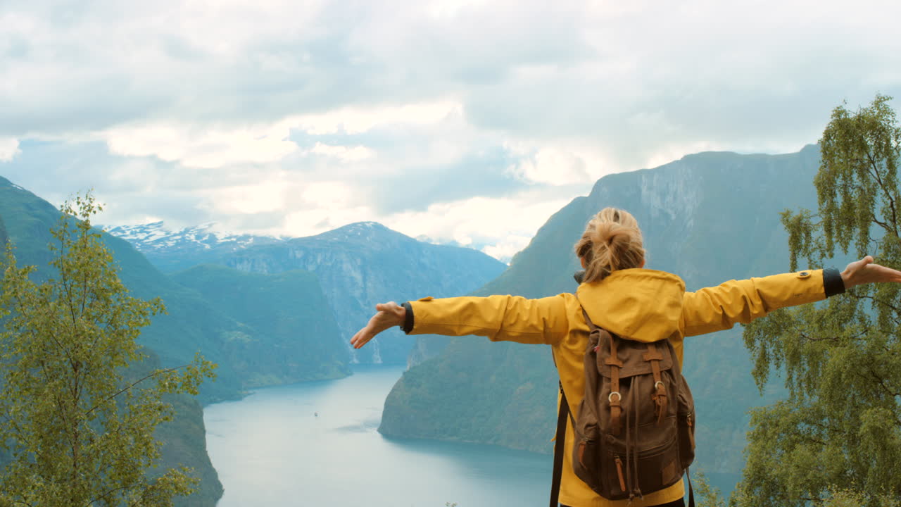 mujer caminando en un paisaje de fiordo
