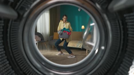 woman loading laundry in washing machine
