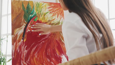 woman artist draws exotic flower touching canvas by finger