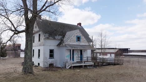 Old-abandoned-houses-with-broken-windows-and-graffiti-sit-empty-on-vacant-property-near-waterfront