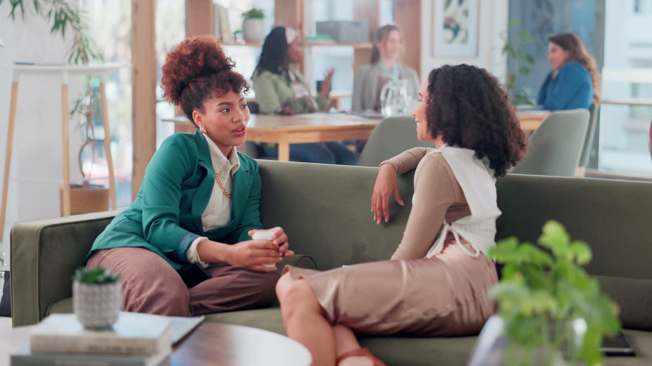 Two Women Colleagues Relaxing and Talking in Modern Office