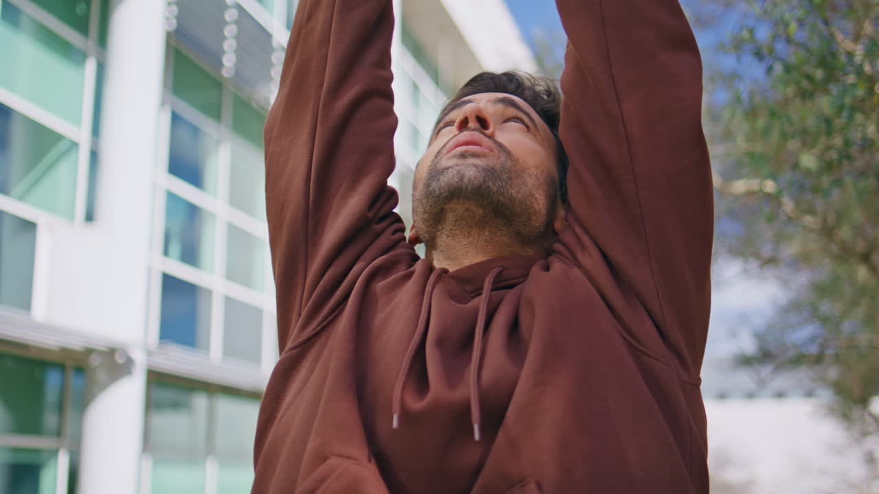 Sport guy preparing workout warming up closeup. Focused bearded athlete training