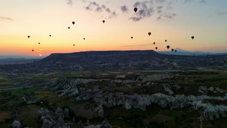 hot air balloons soar over cappadocia's landscape at sunrise