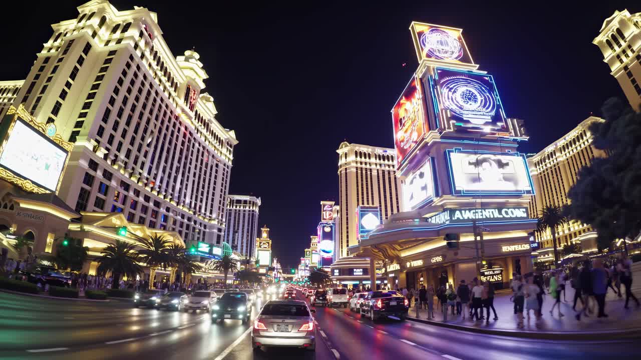 Dynamic street-level video capture of a bustling city at night, showcasing vibrant neon lights