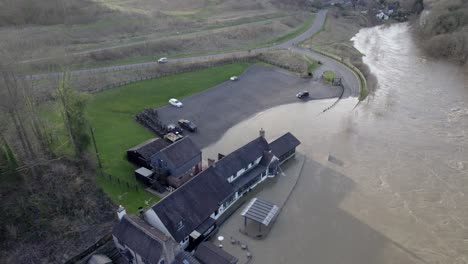 Pub-flooded-river-Severn-in-Ironbridge-England-drone-aerial-view-water-being-pumped-out