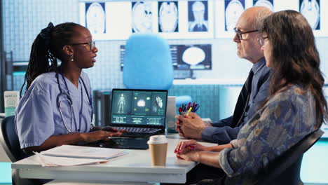 vertical video nurse and patients reviewing diagnostic results in medical cabinet