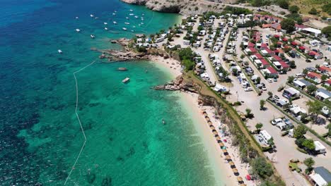 campsite at campig skrila, krk island, stara baska croatia, aerial view of the mountains and coast with boats, beaches and adriatic sea. the seaside rv campmobiles on a summer beautiful coastline