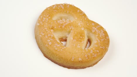 single butter cookie with sugar on a white plate surface