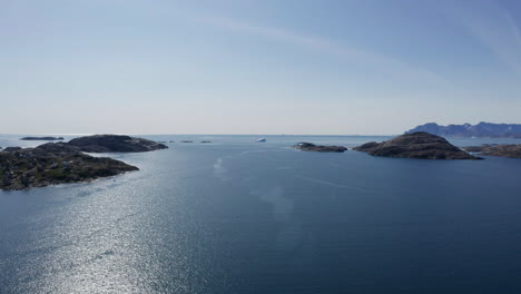 beautiful coastal scenery of greenland from drone over water flying toward open ocean