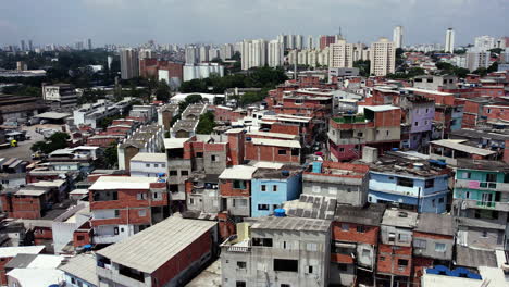 aerial parallax view of metropolitan slum homes in south america, on a sunny day