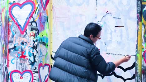 artist creating graffiti art on melbourne's iconic wall