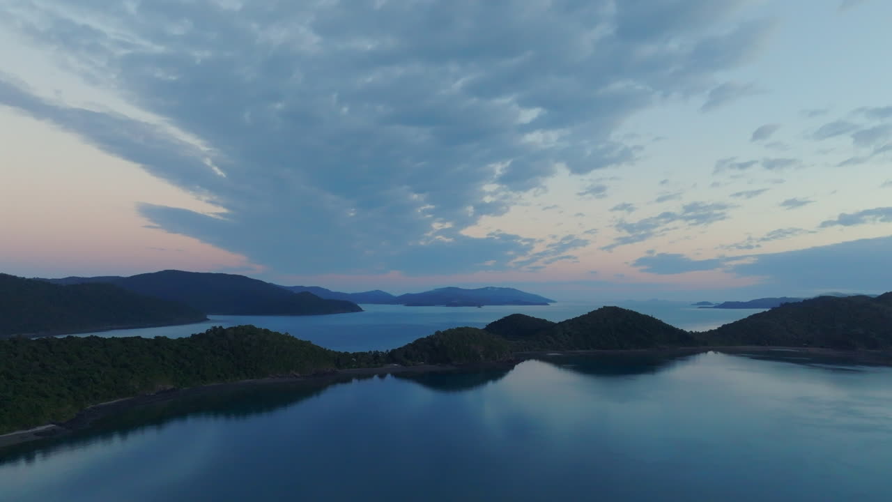Big wide drone shot of Long Island and the mainland towards Shute Harbour in the Whitsundays, QLD, Australia
