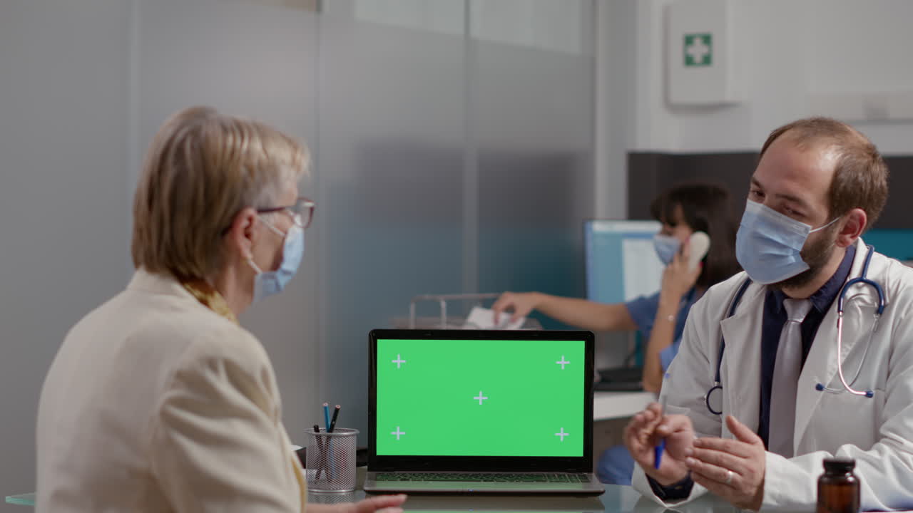 Retired patient and doctor with face mask using greenscreen