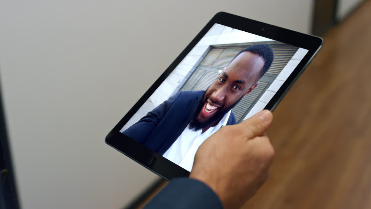Unrecognizable employee video calling colleague by tablet hurrying work closeup
