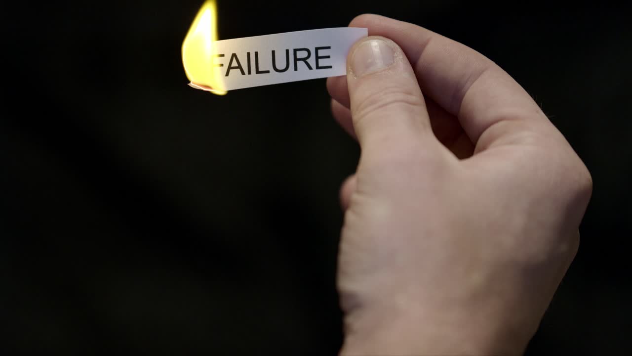 Burning Away Failure - Hand Setting Fire to Paper note Marked “FAILURE”, Powerful Release of Criticism, Guilt and Shame, Dark Cinematic Close-Up. Mental health, therapy