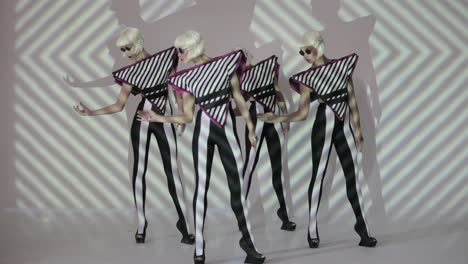 stylish dancers in futuristic costumes