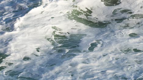 powerful ocean waves crash against rocky formations