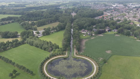 Flying-towards-distant-castle-at-the-edge-of-small-town