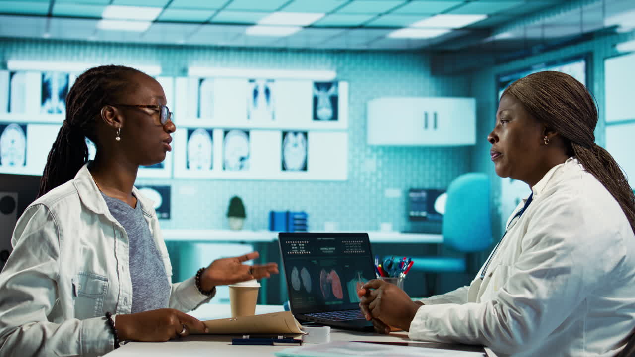 Black general practitioner and patient discussing health care diagnostics