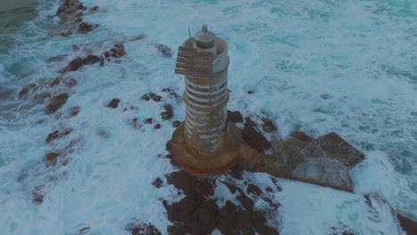 evening serenity: mangiabarche lighthouse at its fullest splendor with waves harmonizing its beauty in sardinia