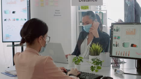 bussines woman with face mask checking financial reports